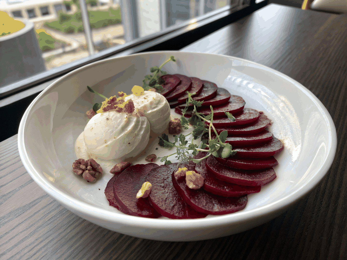 Thinly sliced roasted beets with walnuts and micro-greens